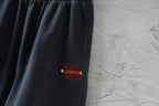 Dark navy shorts with red Balenciaga logo label on side