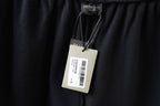 Dark navy shorts with hanging inner brand tag and barcode label