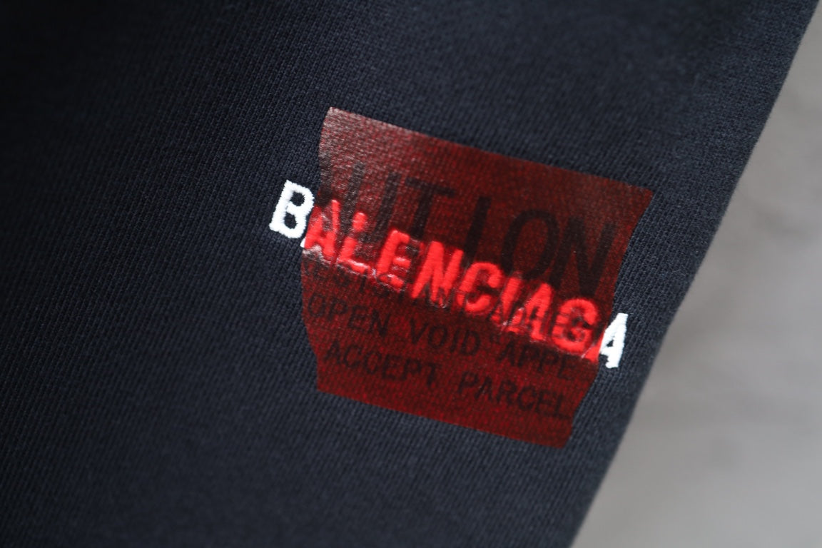 Dark navy fabric close-up with red Balenciaga brand label
