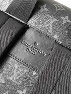 Louis Vuitton label patch stitched on dark monogram fabric strap