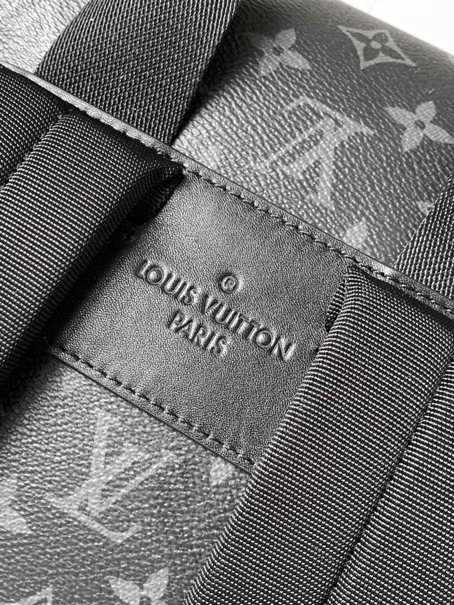 Louis Vuitton label patch stitched on dark monogram fabric strap