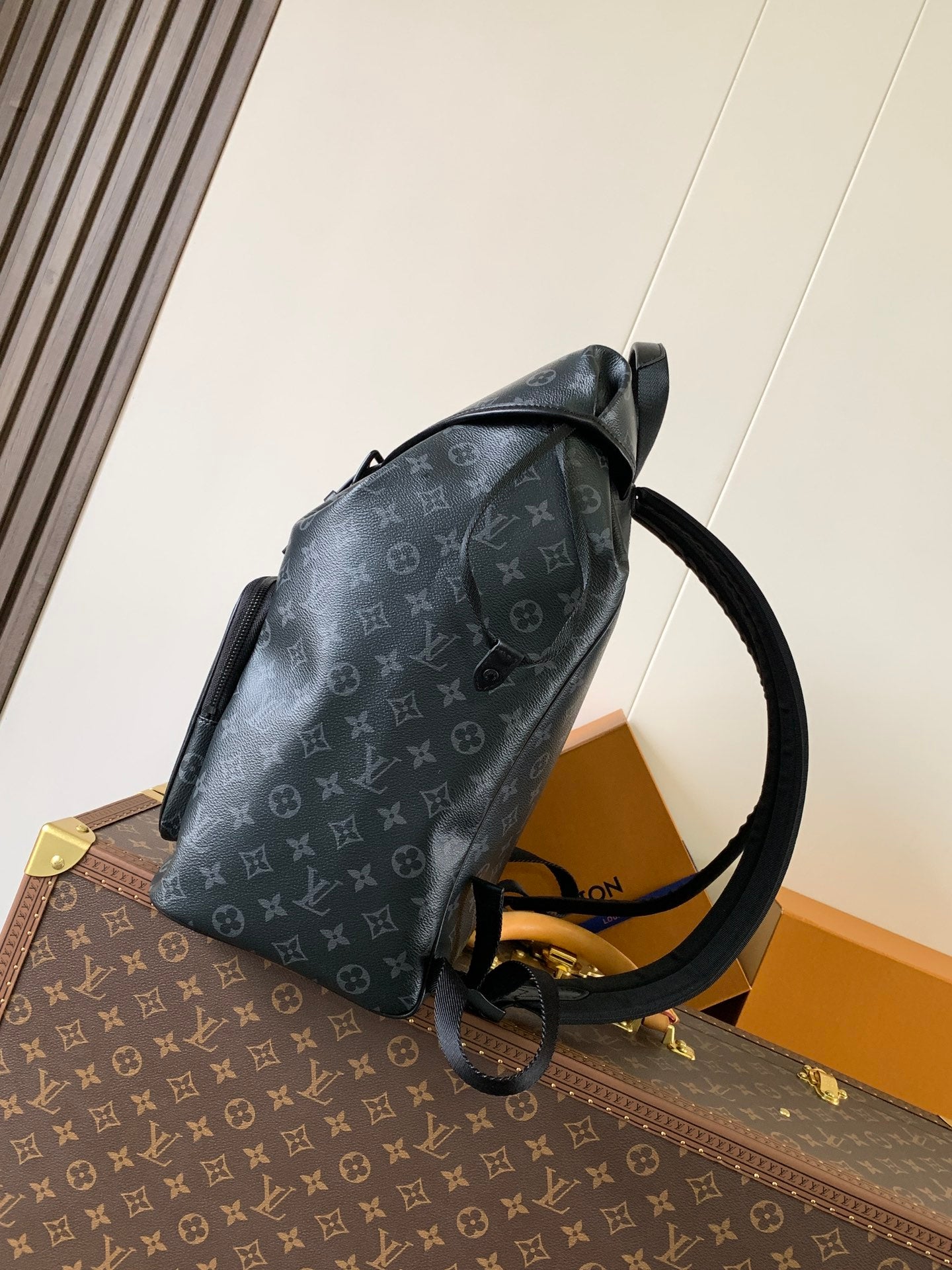 Louis Vuitton monogram backpack side view with adjustable shoulder strap and handle