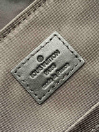 Louis Vuitton label patch with “Louis Vuitton Paris” text on fabric panel