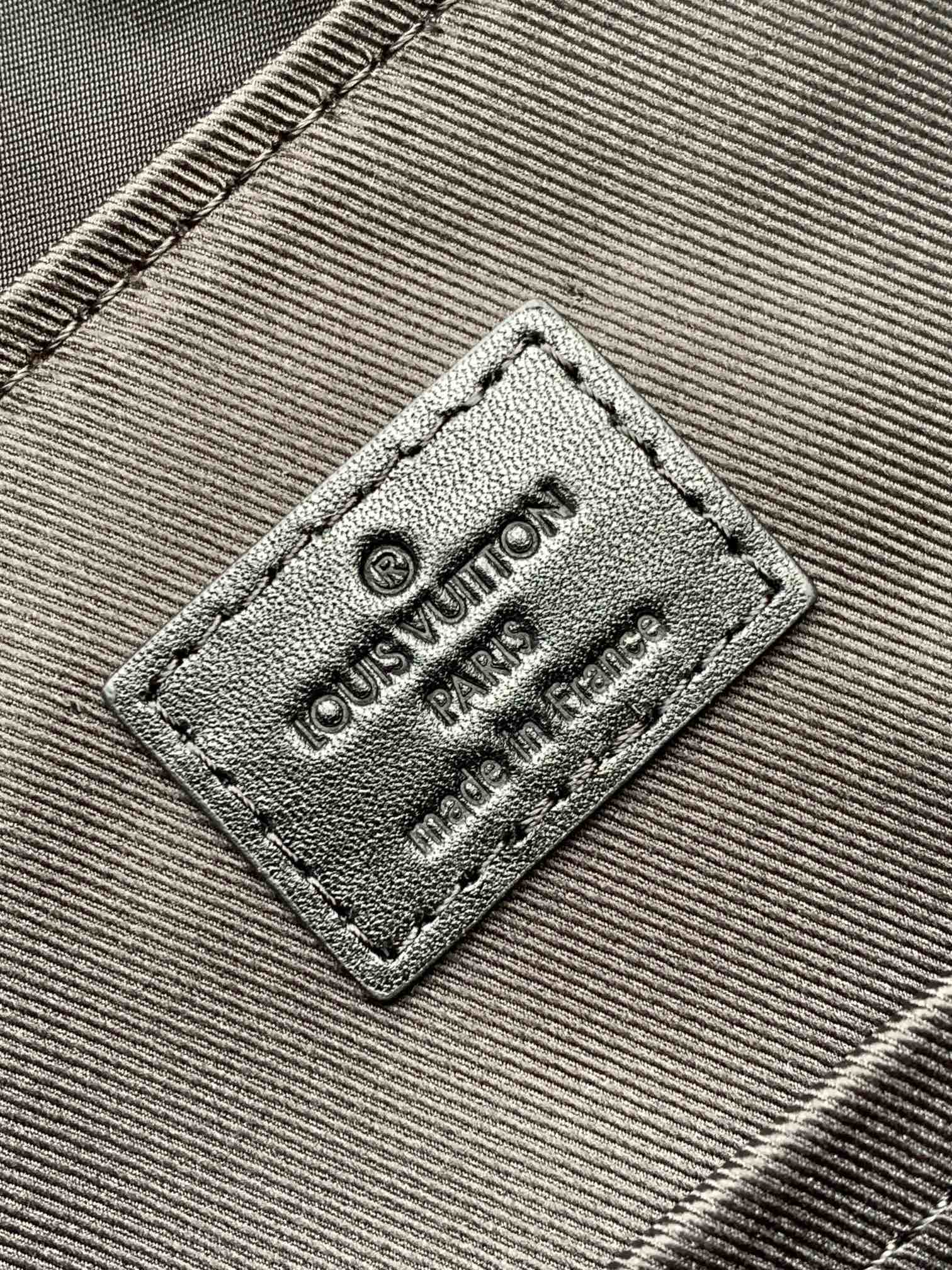 Louis Vuitton label patch with “Louis Vuitton Paris” text on fabric panel