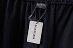 Balenciaga black shorts with hanging brand tag at waistband