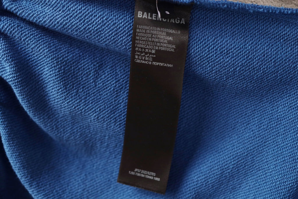 Balenciaga blue pants with black fabric care label inside waistband