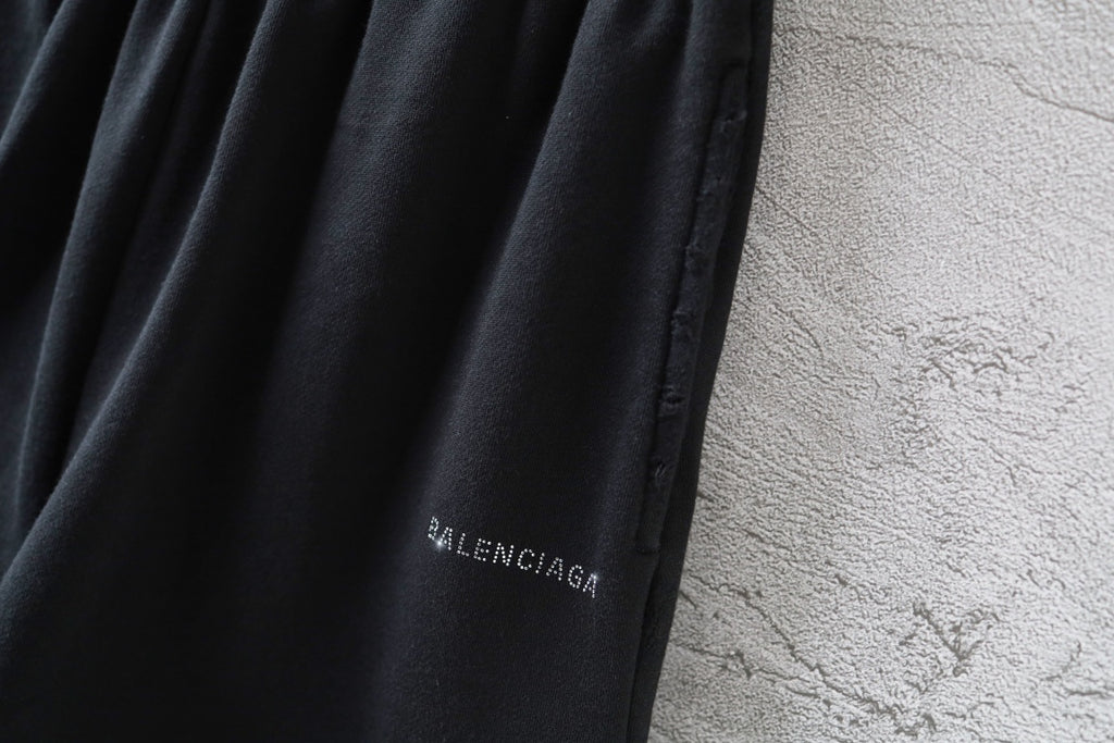 Balenciaga logo patch on black shorts leg