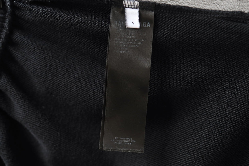 Black shorts fabric with interior care label tag attached