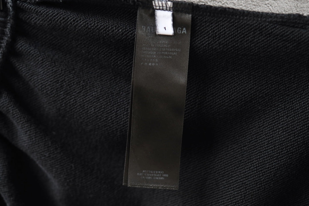 Black shorts fabric with interior care label tag attached
