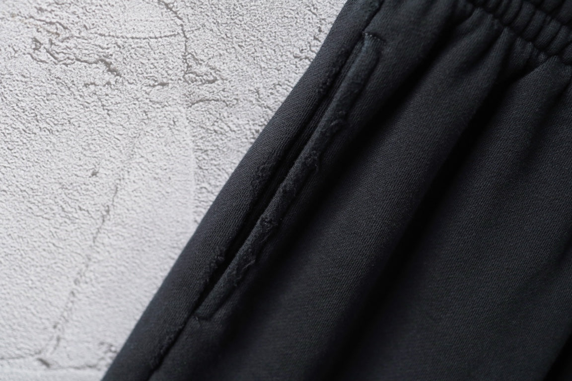 Black shorts fabric with vertical pleats near the waistband