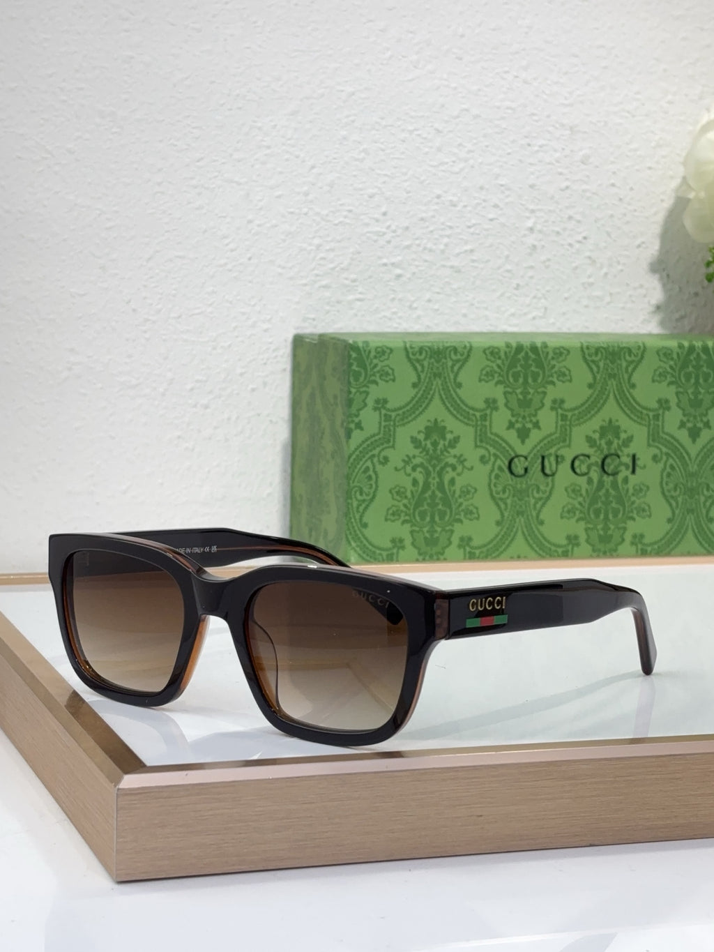 Gucci sunglasses with tortoiseshell frame and dark lenses, front angled view