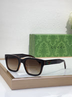 Gucci sunglasses with tortoiseshell frame and dark lenses, front angled view