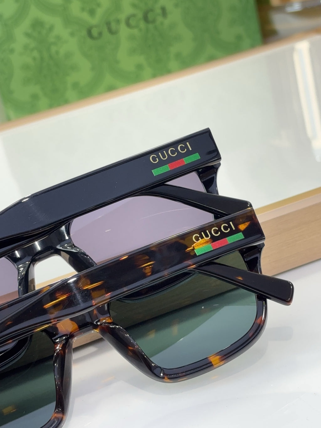 Gucci sunglasses with tortoiseshell frame and tinted lenses, close-up