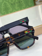 Gucci sunglasses with tortoiseshell frame and tinted lenses, close-up