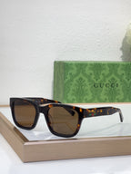 Gucci sunglasses with tortoiseshell frame and dark brown lenses, front view