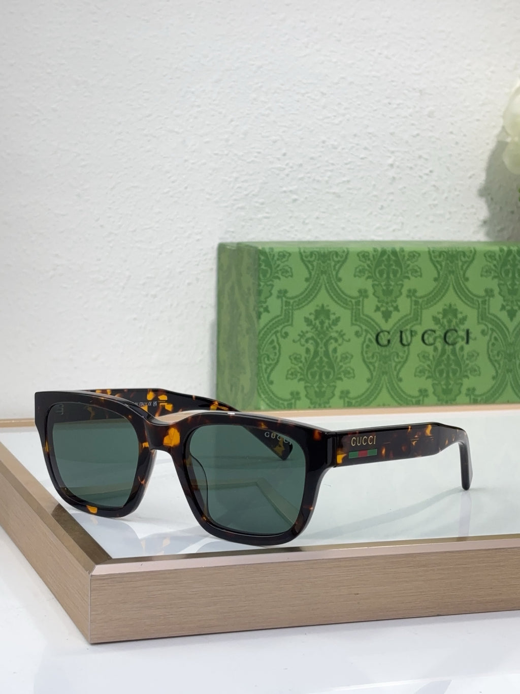 Gucci sunglasses with tortoiseshell frame and dark green lenses, front view