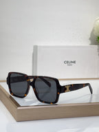 Celine tortoiseshell oversized sunglasses with gold logo detail and dark tinted lenses