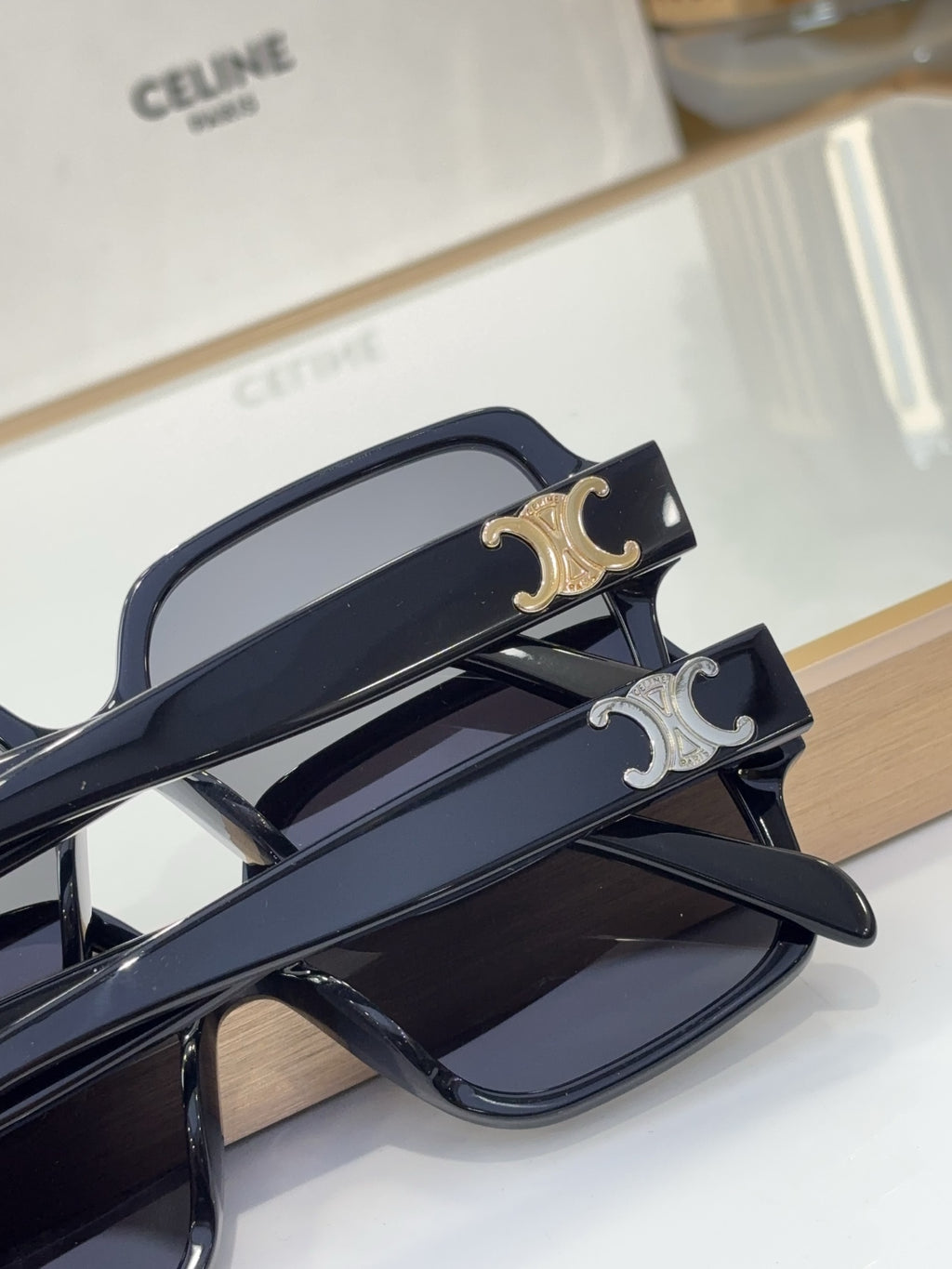 Celine navy sunglasses with silver logo detail, dark lenses, and angular temple