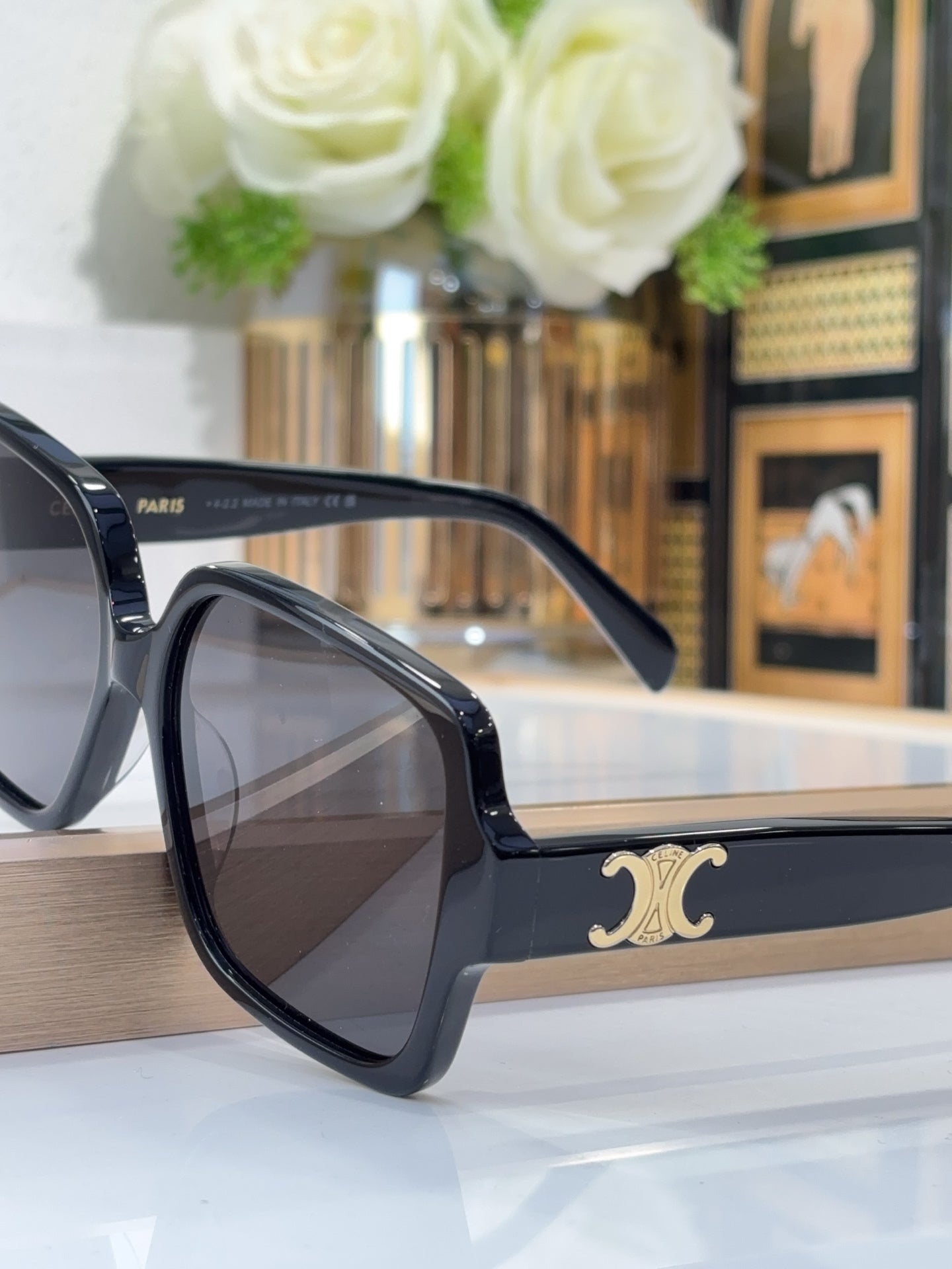 Celine black cat-eye sunglasses with gold logo on temple and dark tinted lenses