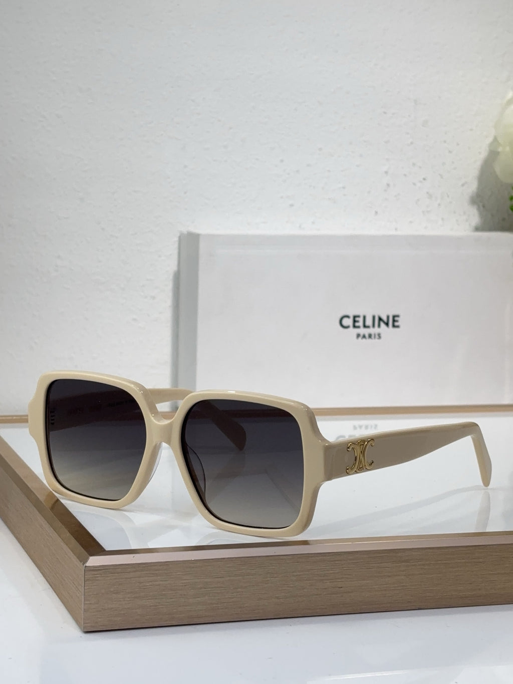 Celine light beige oversized sunglasses with gold logo detail and dark lenses