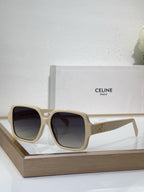 Celine light beige oversized sunglasses with gold logo detail and dark lenses