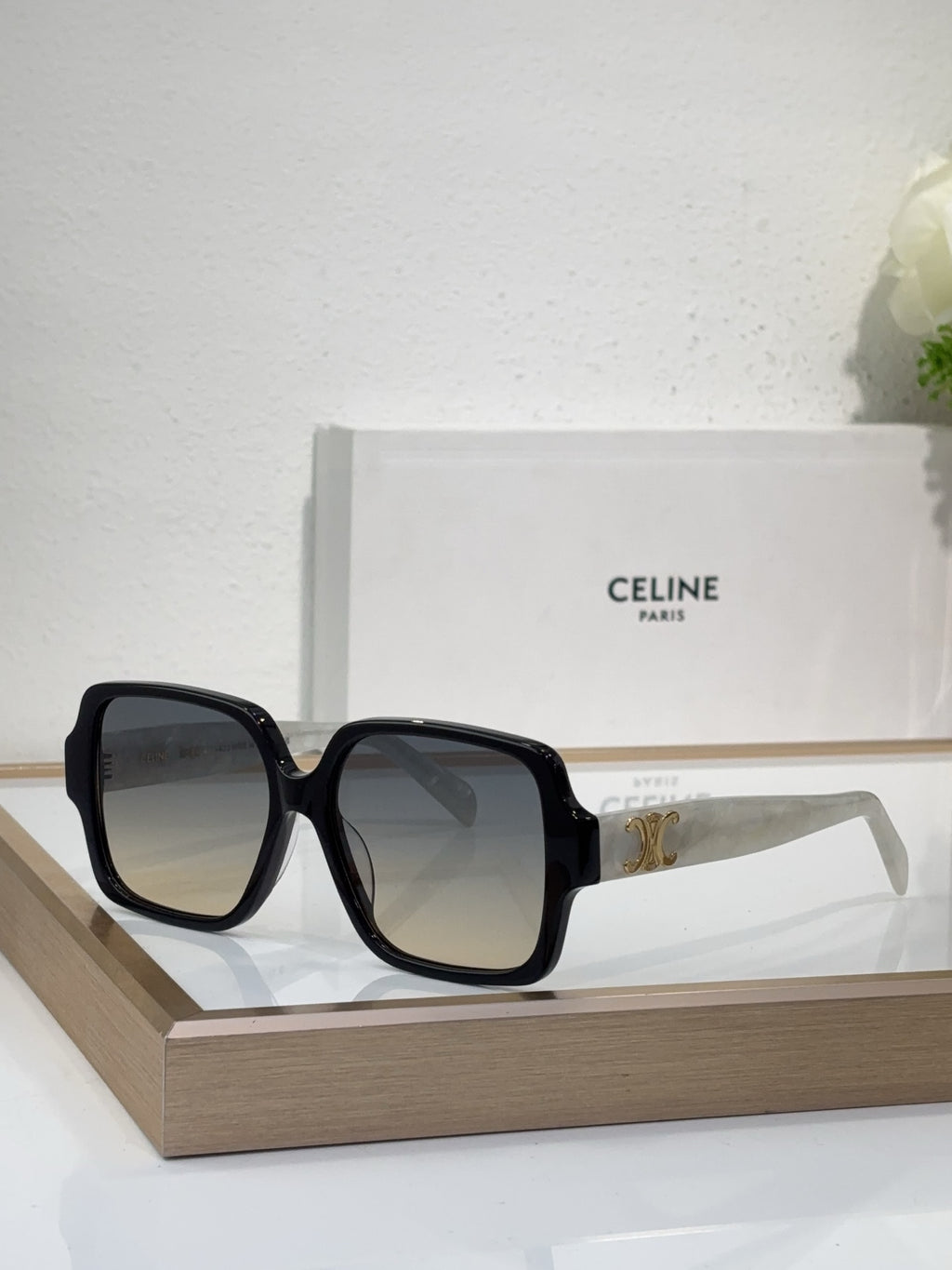 Celine black oversized sunglasses with gold logo detail and smoky tinted lenses