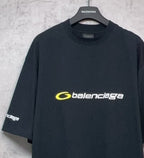 Dark crewneck T-shirt with centered yellow Balenciaga logo and side sleeve print