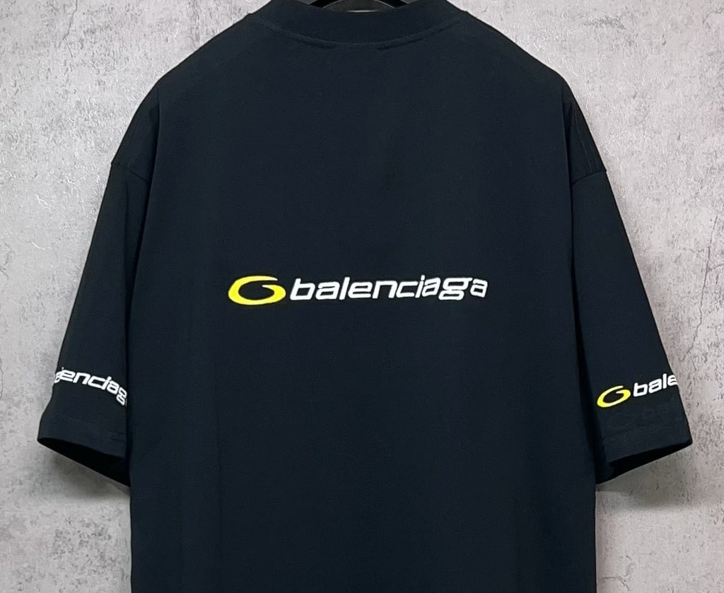 Dark crewneck T-shirt back view with yellow Balenciaga logo and side sleeve print