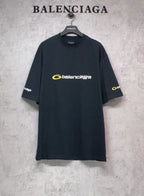 Dark T-shirt with crew neck, yellow Balenciaga logo on chest and sleeve prints