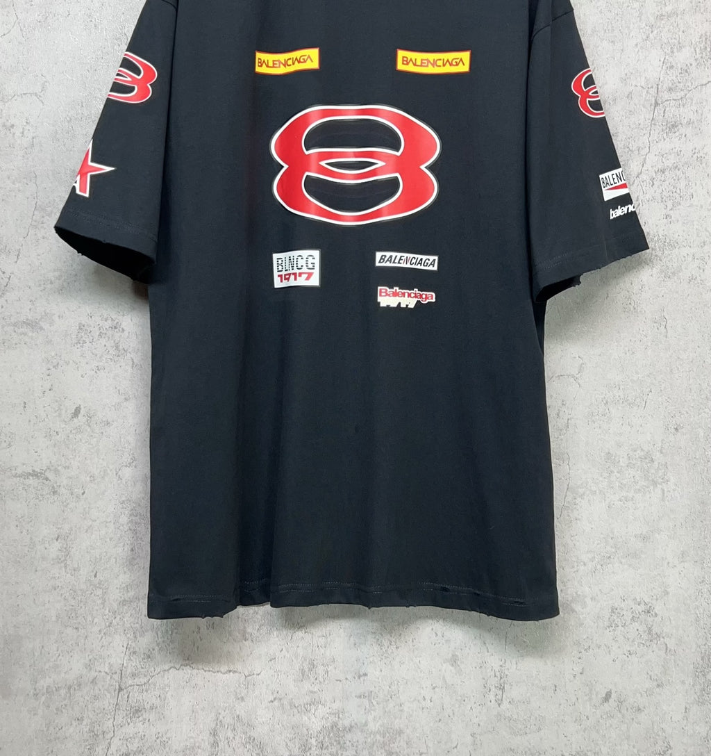 Dark navy short-sleeve T-shirt front view with red B emblem and multiple logo patches.