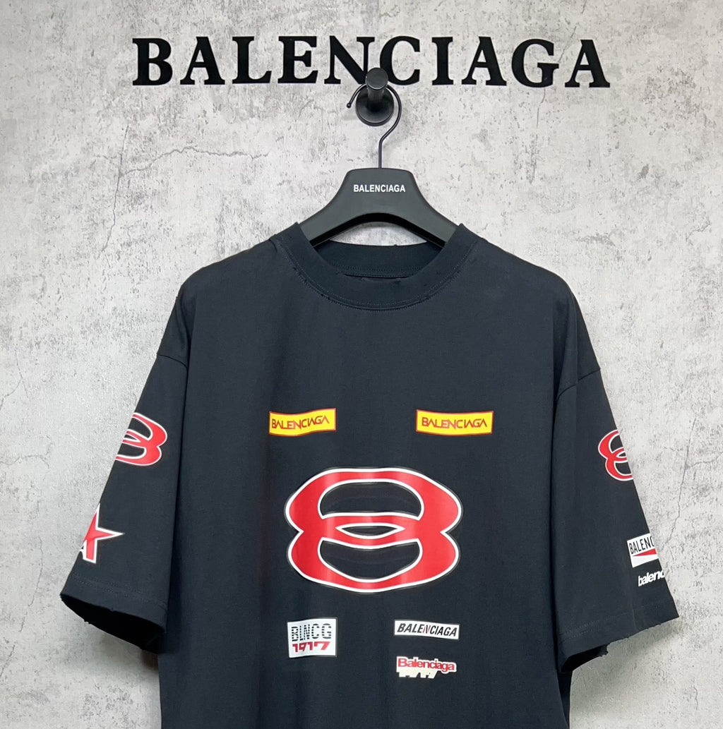 Dark navy short-sleeve T-shirt with large red B emblem and small logo labels.
