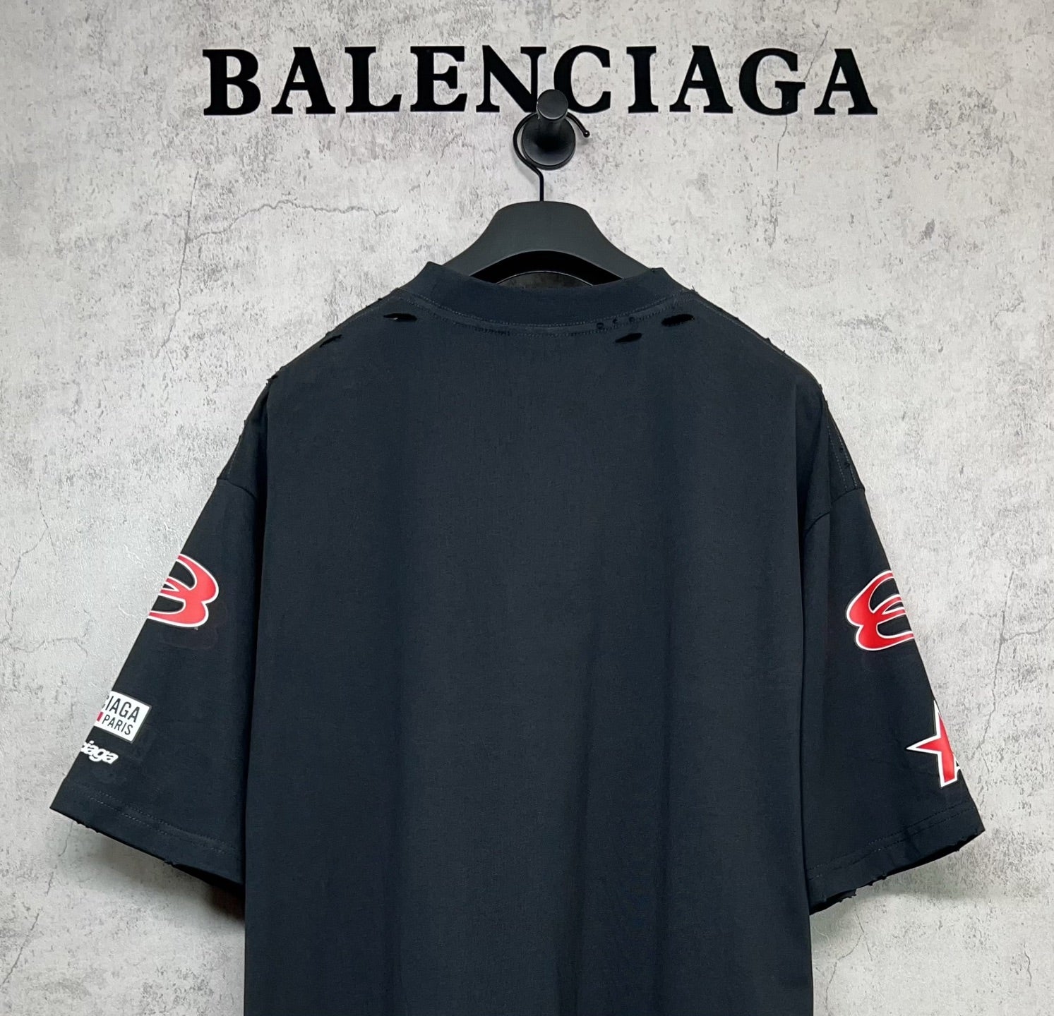 Dark navy short-sleeve T-shirt shown from back with sleeve prints and no front graphics.