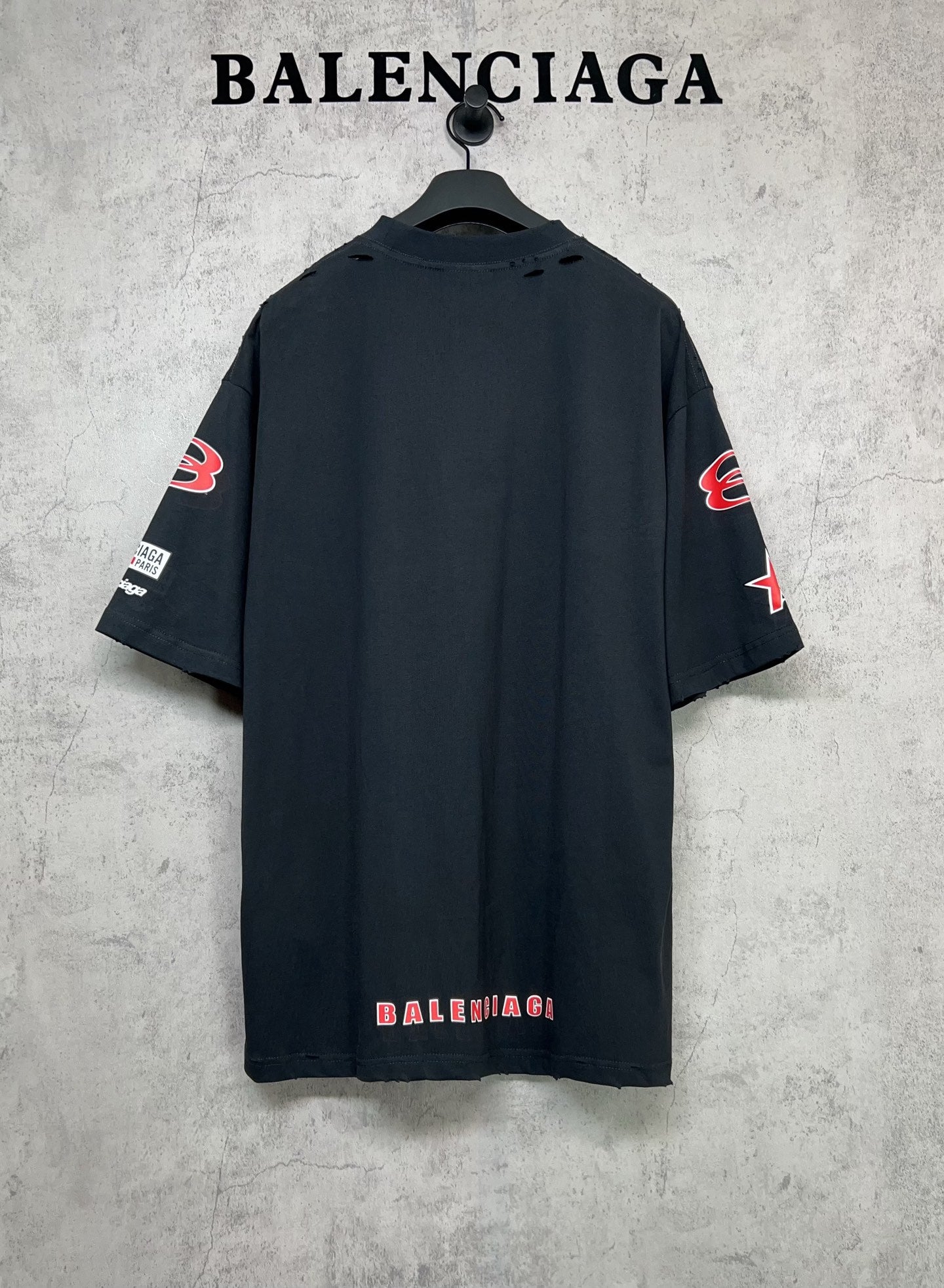 Dark navy short-sleeve T-shirt shown from back with BALENCIAGA print and sleeve logos.