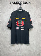 Dark navy short-sleeve T-shirt with large red B graphic and multicolor logo patches.