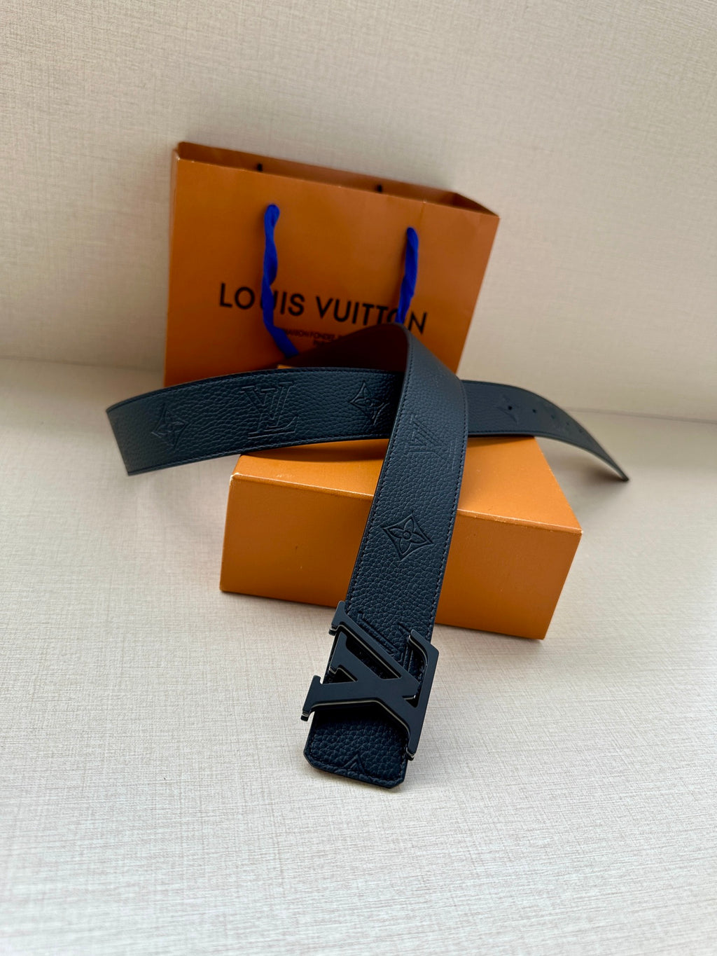 Blue textured leather belt with large LV buckle and strap keeper loop