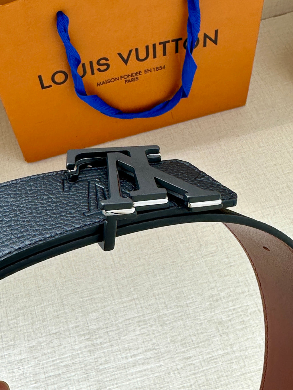 Blue textured leather belt with metal LV buckle clasp and pin strap