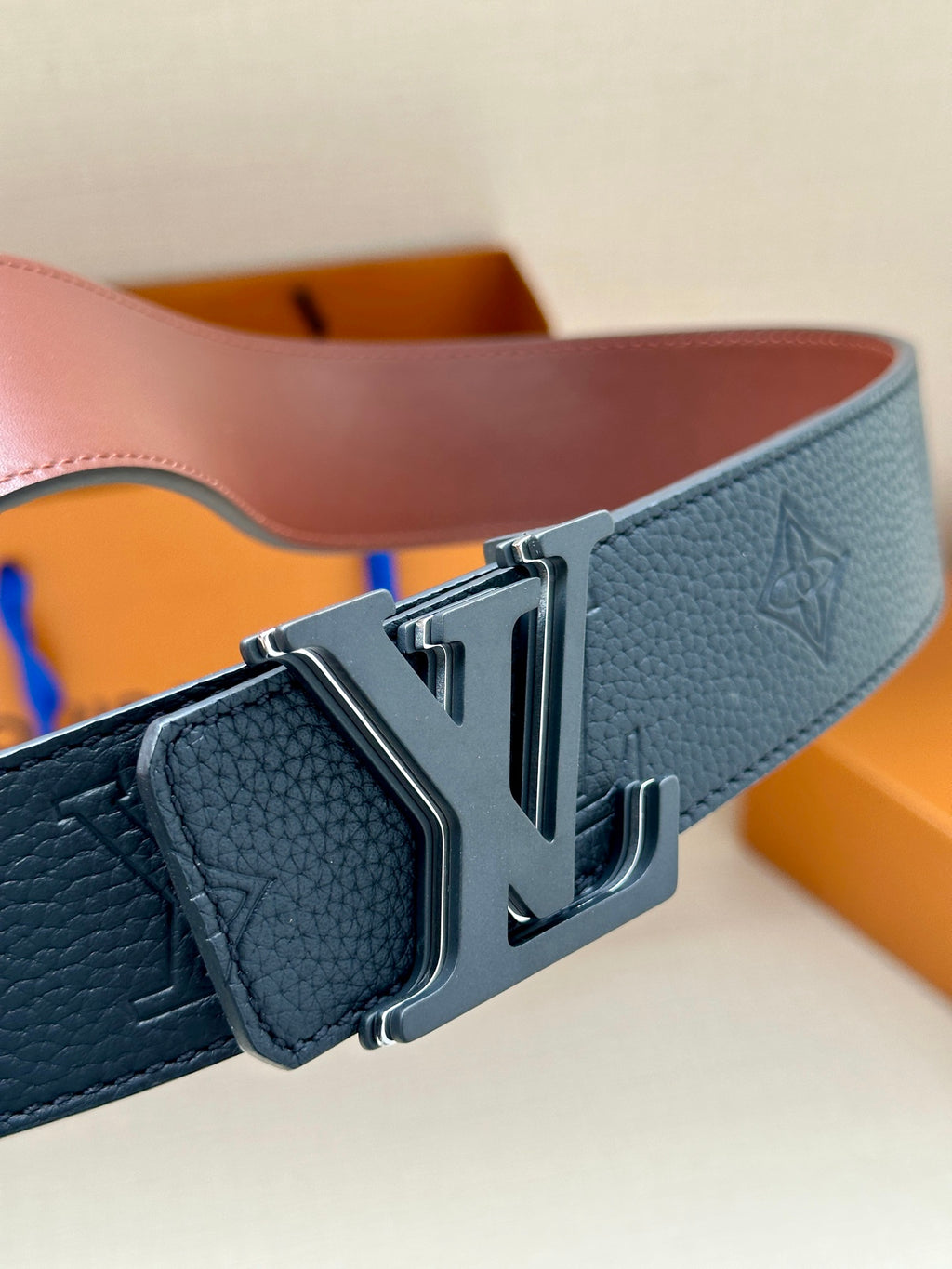 Blue textured leather belt with silver-toned LV buckle detail