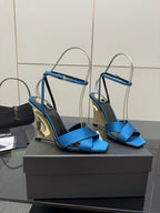 Blue strappy high-heel sandals with ankle strap and pointed toe