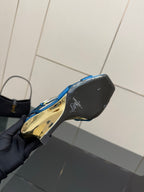 Heel view of blue strappy high-heel sandals with gold accent at the back
