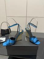 Blue strappy high-heel sandals with open toe, ankle strap, and stiletto heel