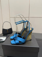 Blue strappy high-heel sandals with crisscross straps and tall stiletto heel
