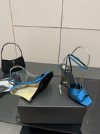 Pair of blue strappy high-heel sandals with open toe and thin ankle strap