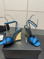 Blue strappy high-heel sandals with open toe and glossy gold heel cap