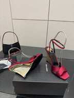 Women's heeled sandals with pink bow straps and mirrored gold heel, side view on box