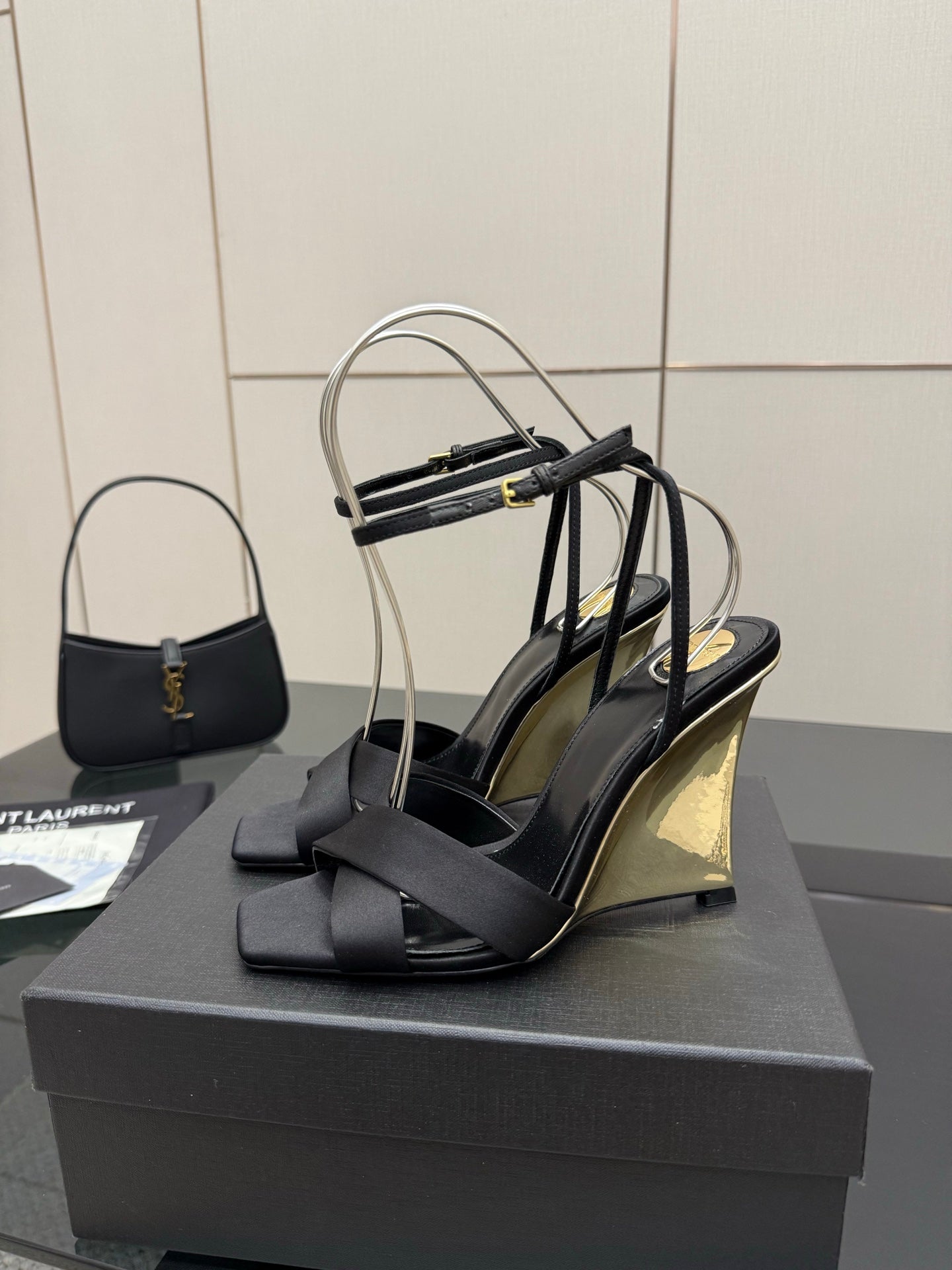 Black platform wedge sandal with open toe and stacked heel, bow-like strap detail