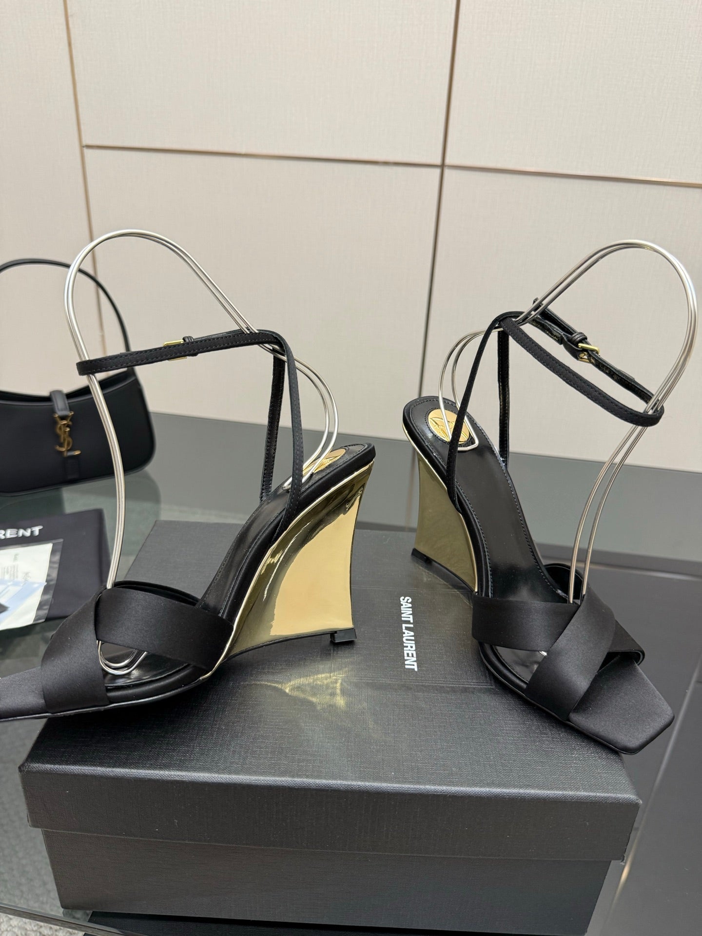 Black platform wedge sandals with open toe, slingback strap, and gold insole trim