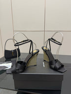 Black platform wedge sandals with open toe, crisscross straps, and rounded heel
