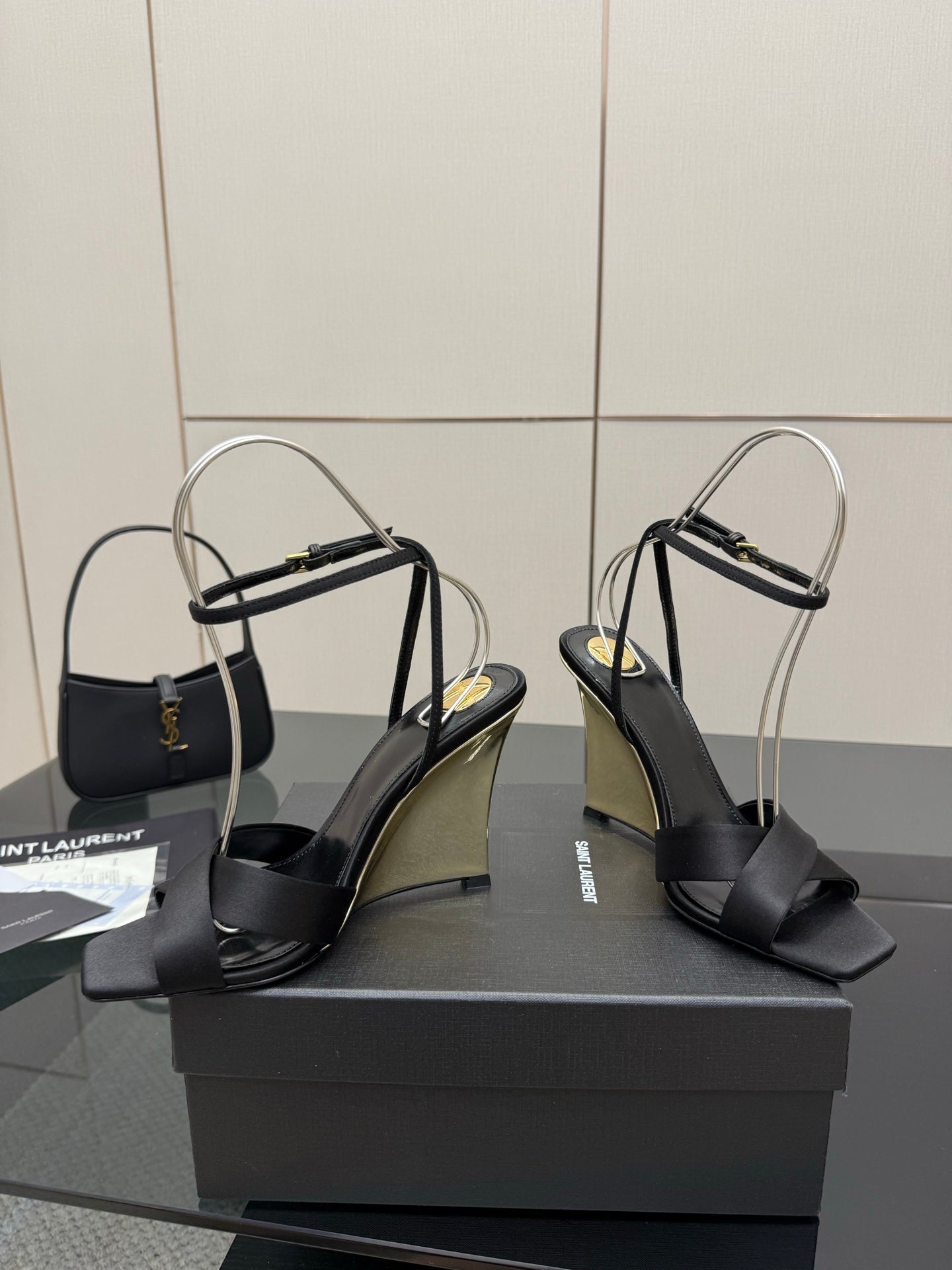 Black platform wedge sandals with open toe, crisscross straps, and rounded heel
