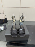 Black heeled sandal with wide ankle straps and gold trim detail