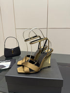 Gold open-toe heeled sandals with silver ankle straps and chunky wedge heel